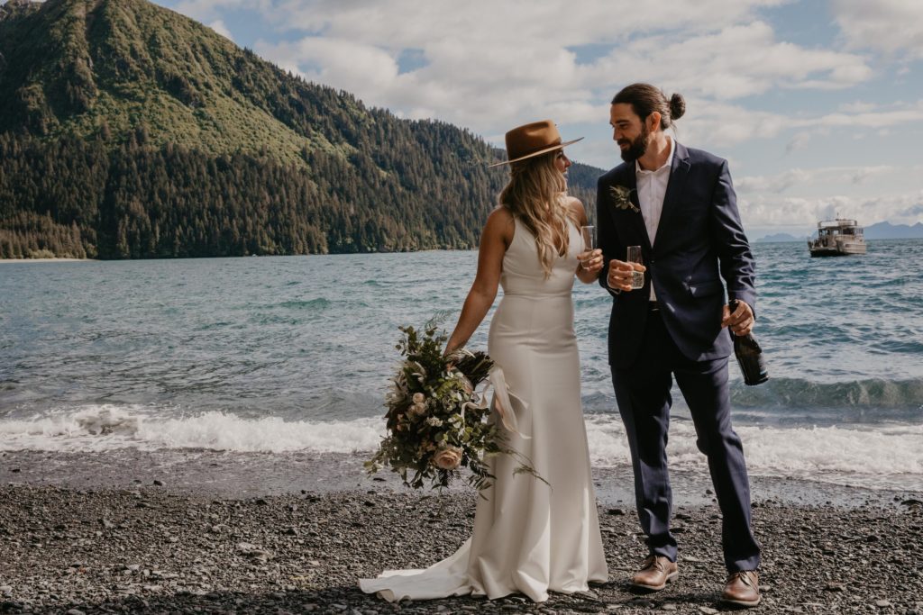 Couple celebrates with champagne at Millers Landing Beach Elopement