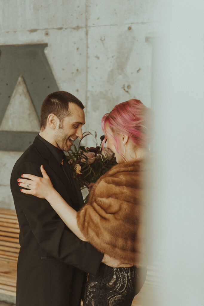 happy bride and groom laughing with each other