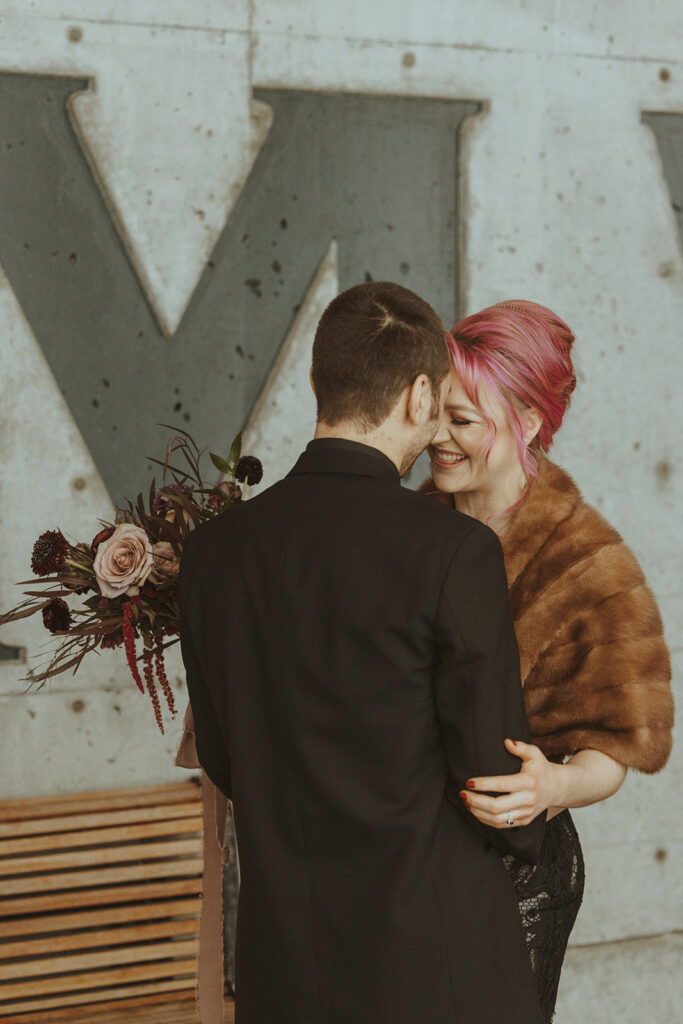 bride and groom looking at each other 