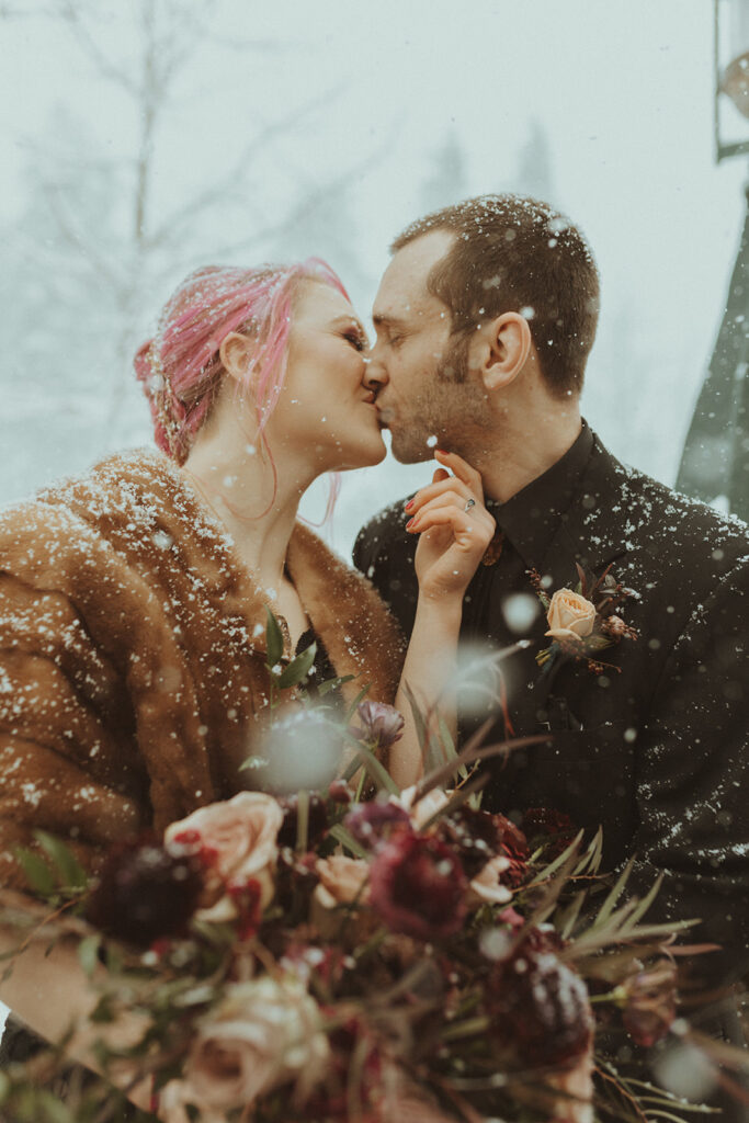 bride and groom kissing at their winter elopement