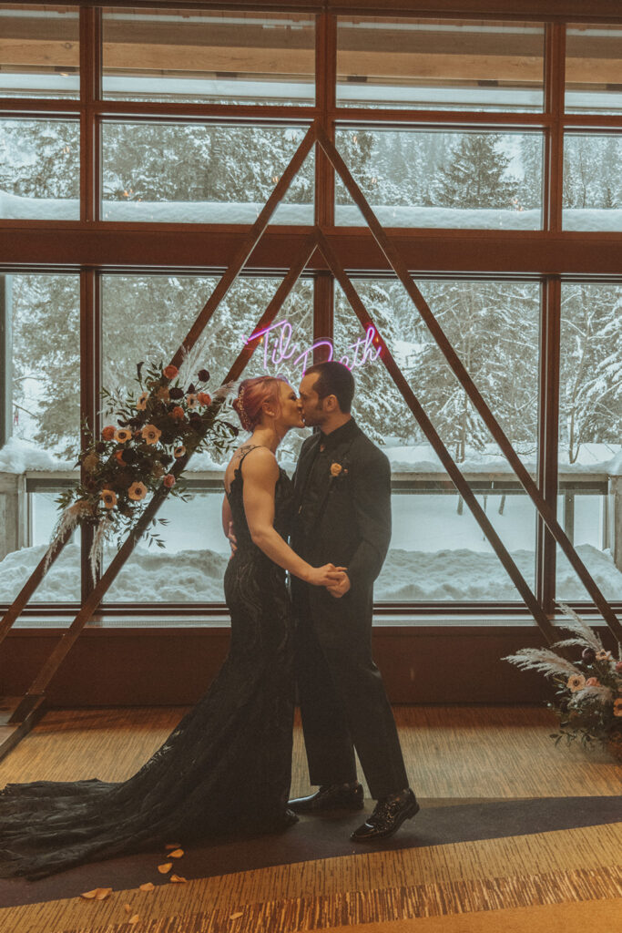 bride and groom kissing after their wedding ceremony 