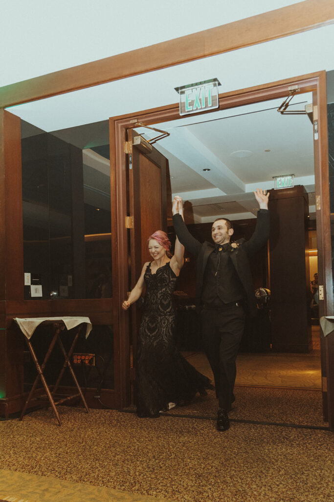 bride and groom entering their wedding reception