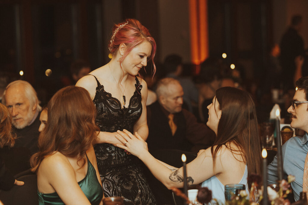 bride talking with her wedding guests at her winter elopement