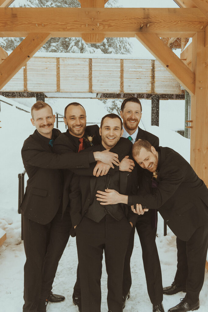 funny picture of the groom and the groomsmen before the winter elopement ceremony