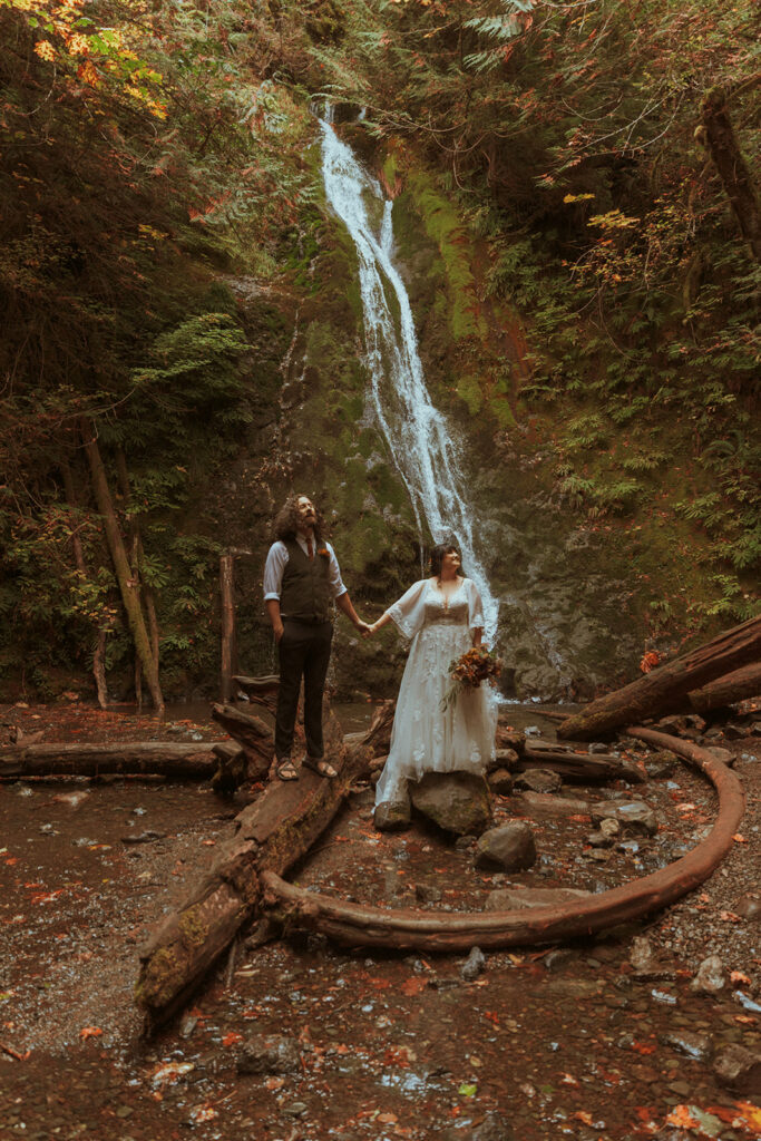 couple at their elopement photoshoot with a cascade in the backdrop