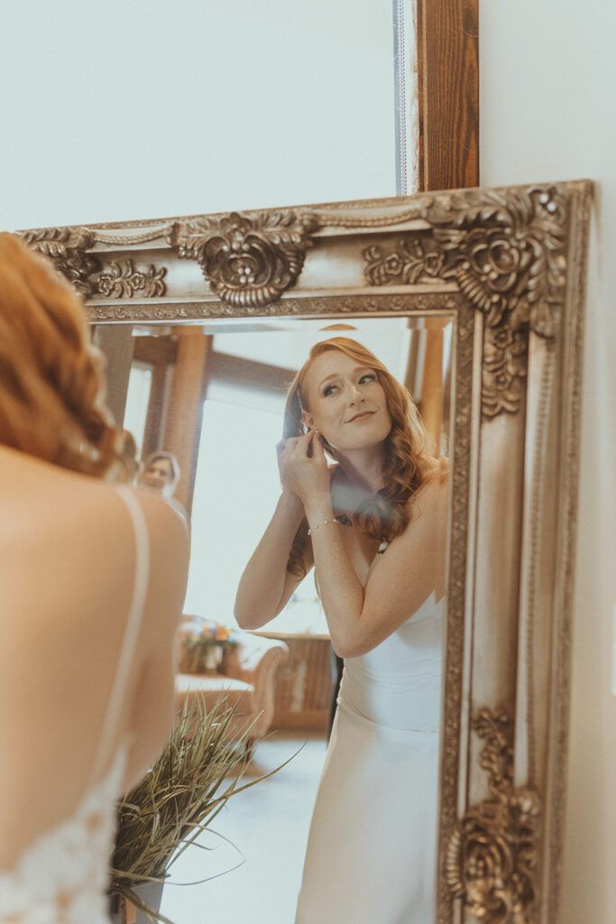 bride putting on her jewelry before her spring colorful wedding ceremony 