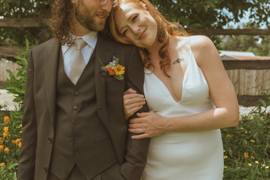 groom resting her head on the grooms shoulder 