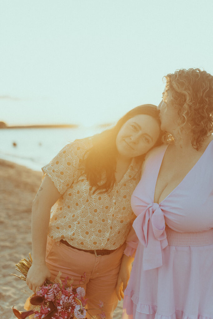 bride kissing her bride on the forehead 