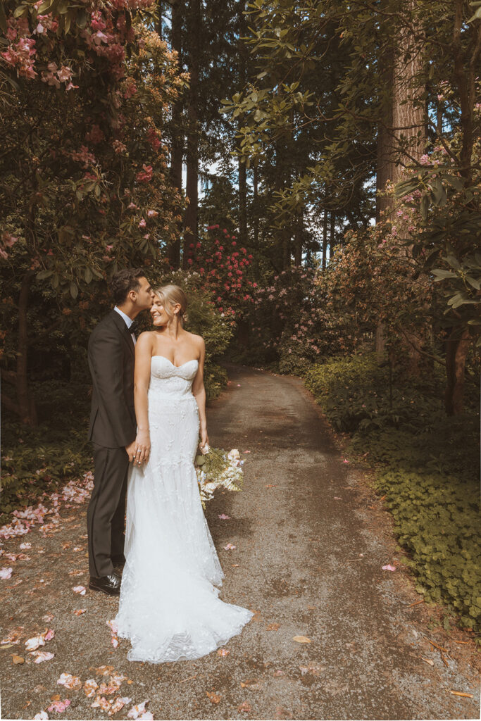 newly married couple kissing during their wedding portraits