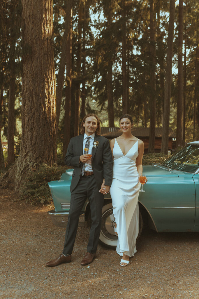 picture of the bride and groom with a vintage car 