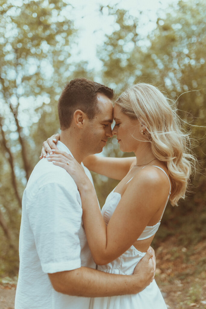 cute couple looking at each other during their engagement photoshoot