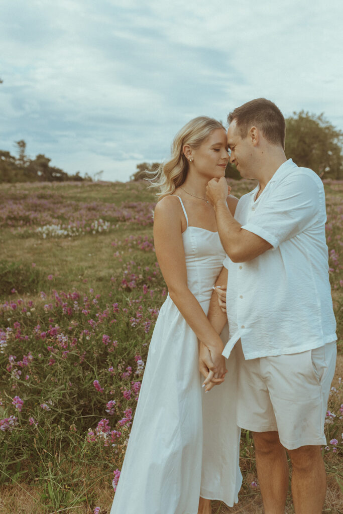 newly engaged couple looking at each other 