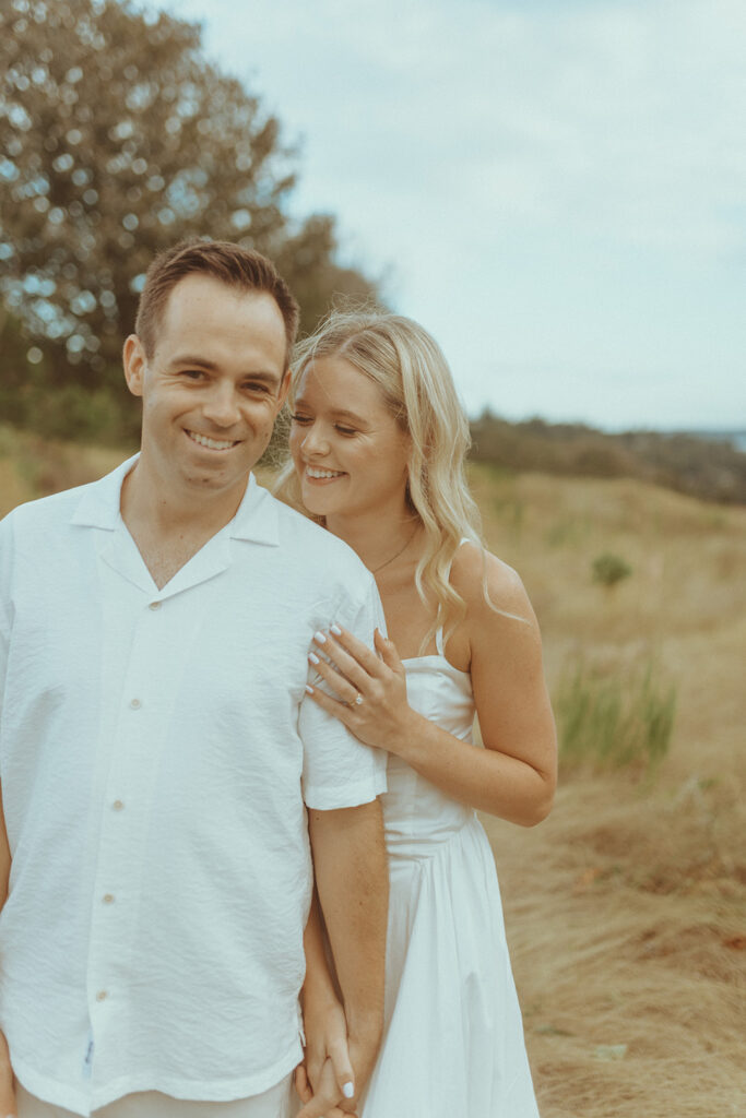 couple smiling at the camera during their photoshoot