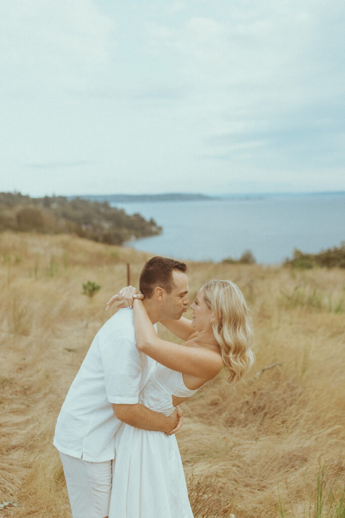 newly engaged couple kissing 