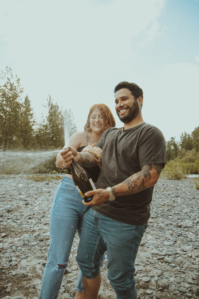 couple drinking champagne at their engagement session