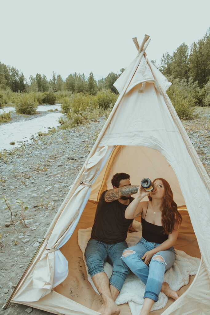 couple drinking champagne at their engagement session