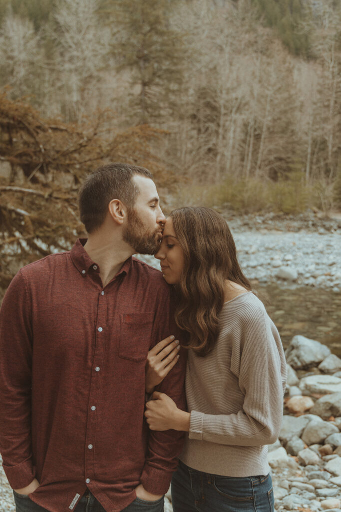 fiance kissing his fiance on the forehead 