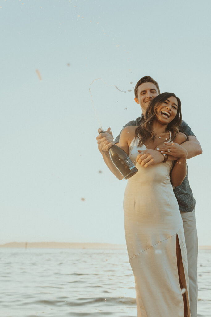 couple celebrating their engagement with champagne 