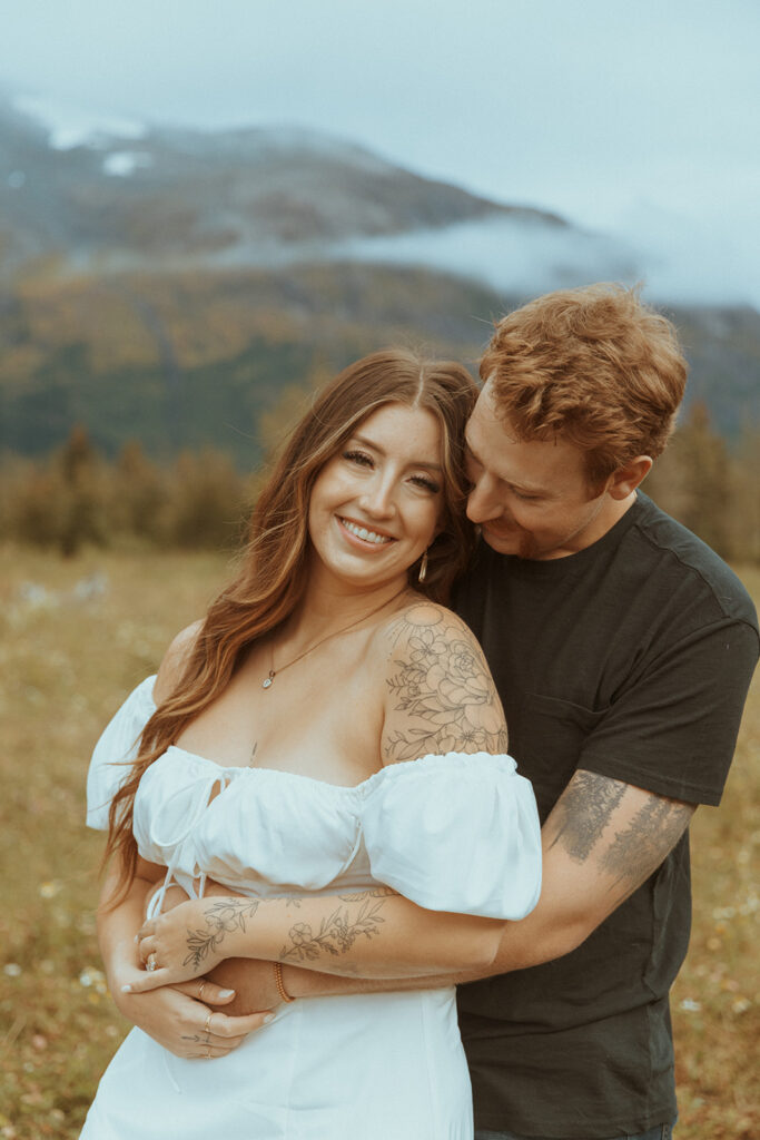 couple laughing looking at the camera during their photoshoto 