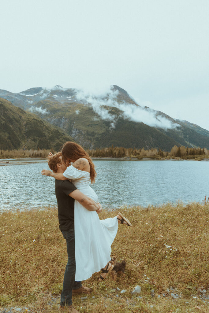 cute couple kissing during their whimsical engagement session