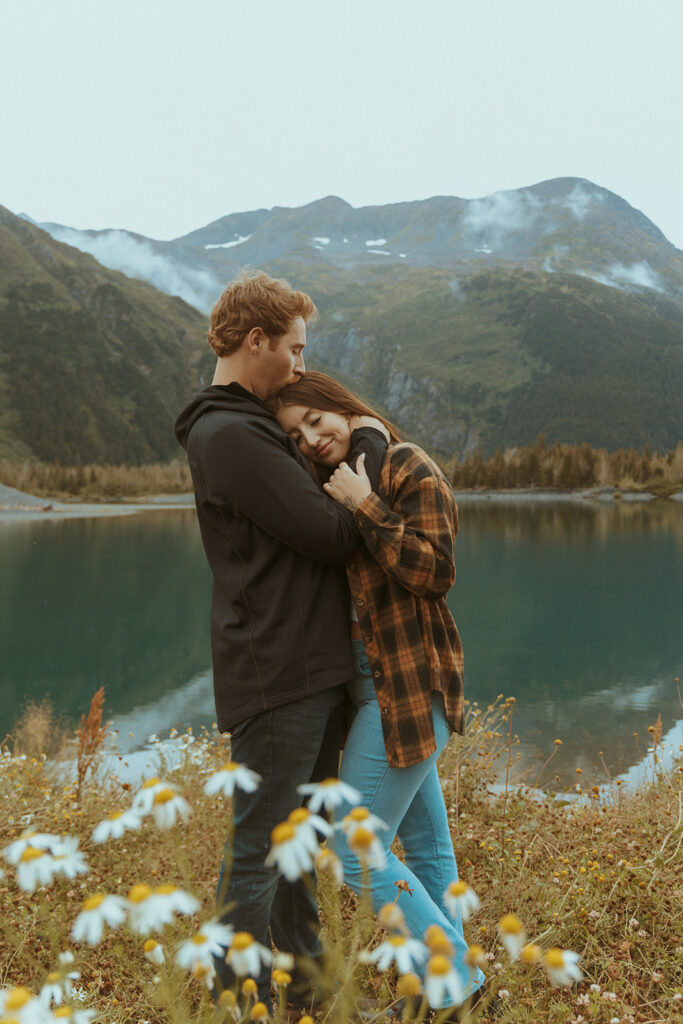 fiance kissing his fiance on the forehead 