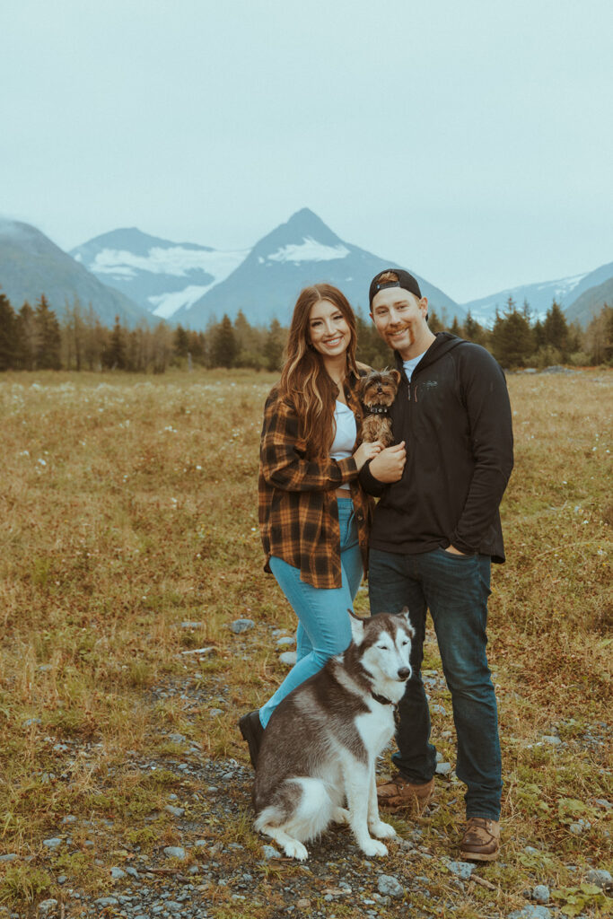 couple at their whimsical engagement session with their dogs 