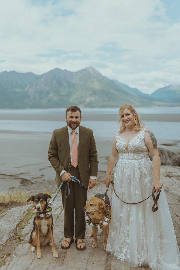 bride and groom with their dogs at their romantic wedding at creekbend cafe in alaska