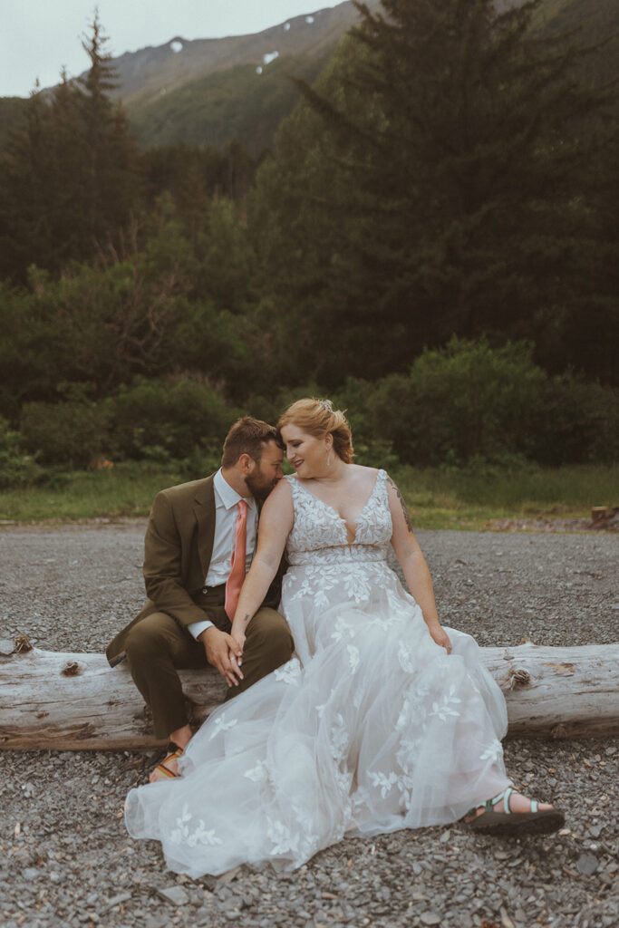 groom kissing the bride on the shoulder at creekbend cafe in alaska