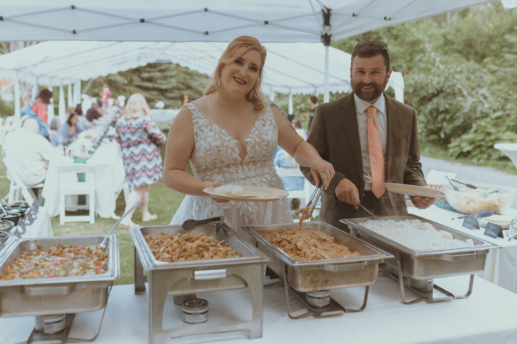 bride and groom having food at their reception