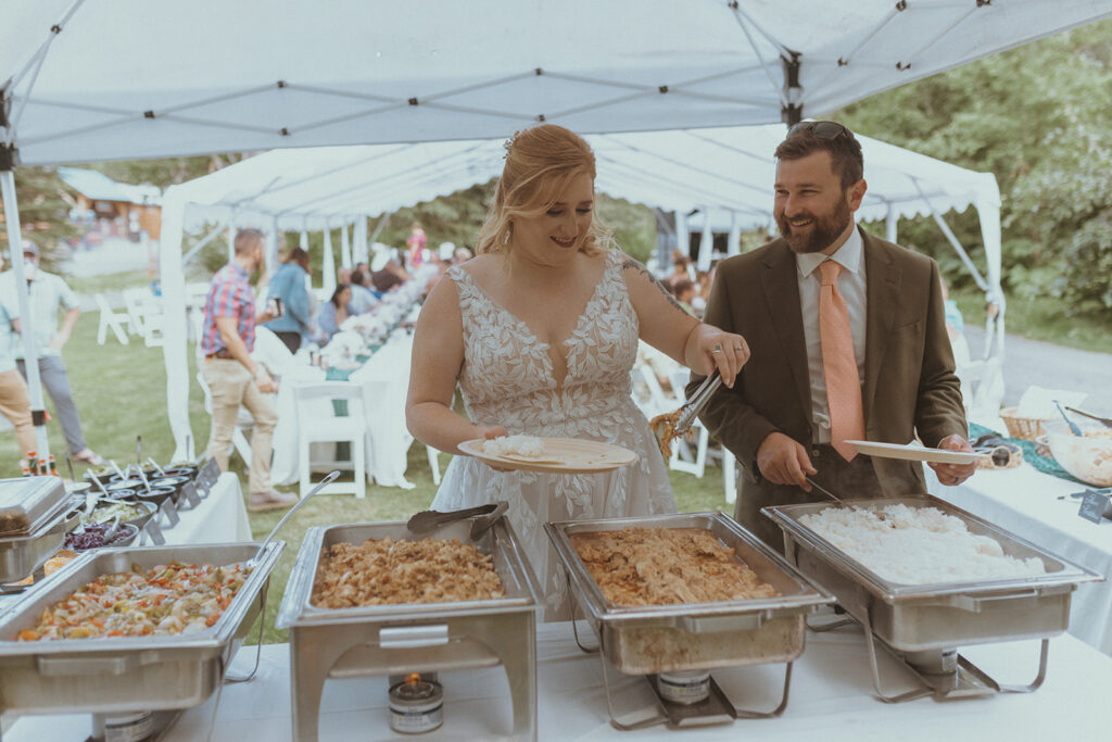 newlyweds having food at their wedding reception