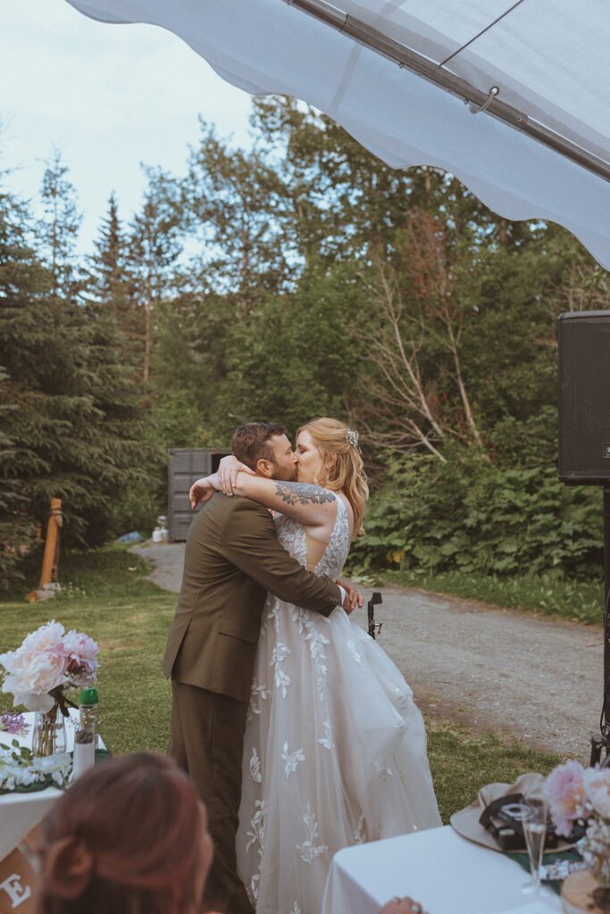 bride and groom kissing at creekbend cafe in alaska