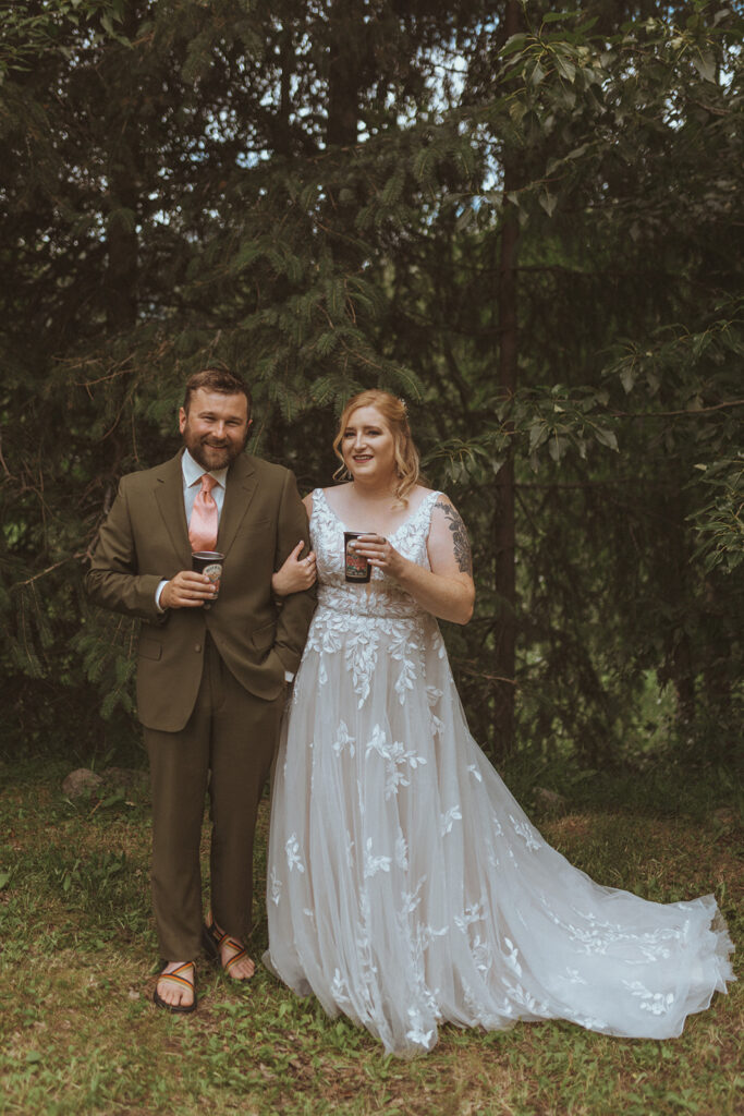 bride and groom holding hands looking at the camera 