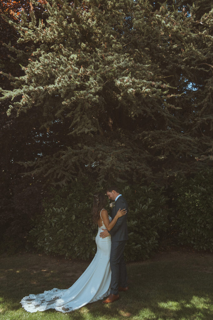 cute picture of the bride and groom hugging 