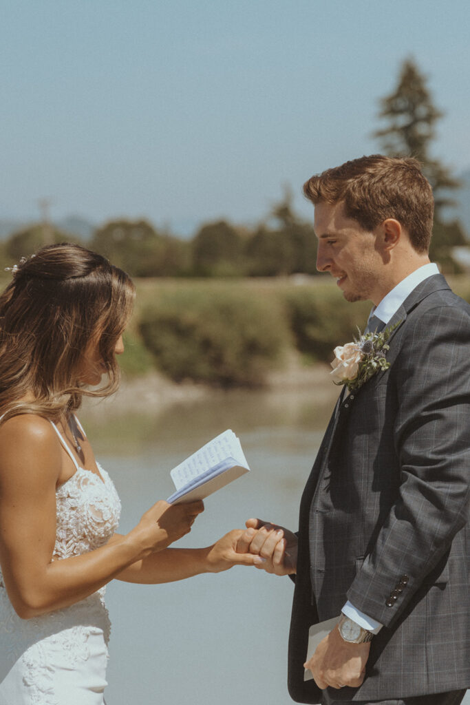 bride and groom reading their private vows