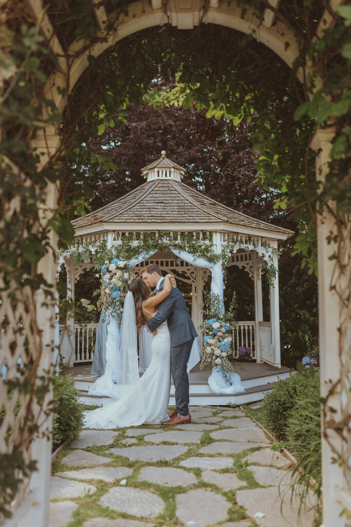 bride and groom kissing after their wedding ceremony 