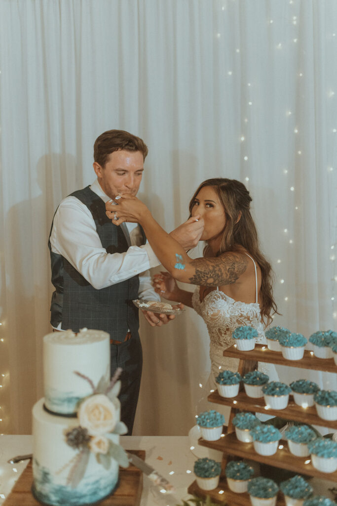 cute couple trying their wedding cake  