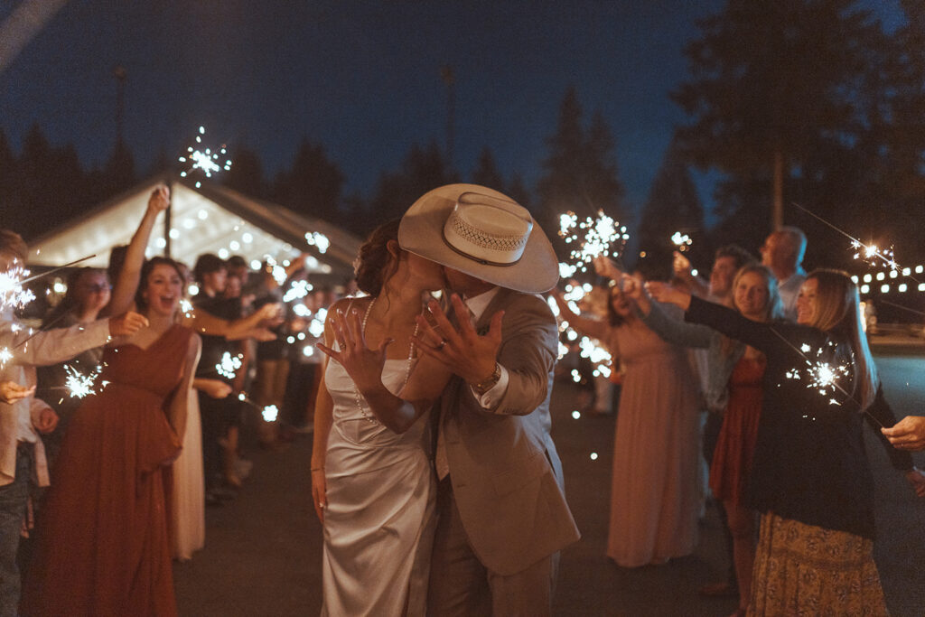 couple showing their wedding rings at their dream backyard wedding