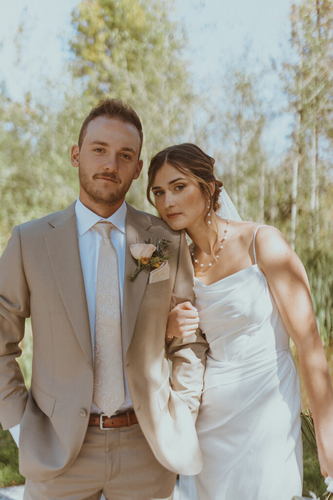 cute picture of the bride and groom posing for the camera 