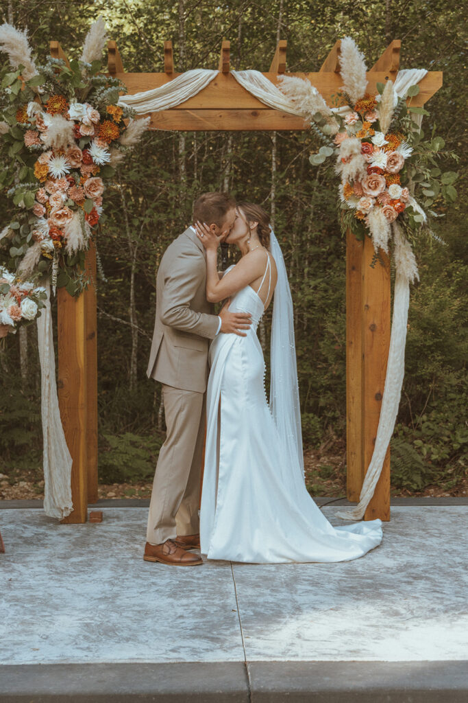 newly married couple kissing after their ceremony