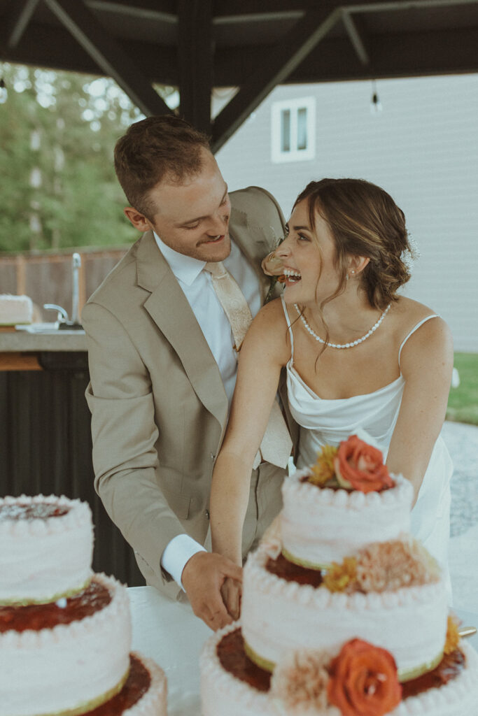 bride and groom cutting their wedding cake 