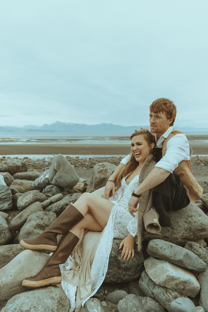 Nordic style bride and groom relax on beach 