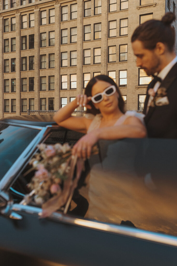 Bride looks over trendy glasses at groom 