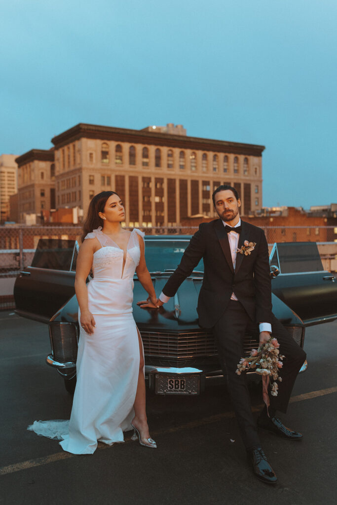 Bride and Groom Hold Hands over Car